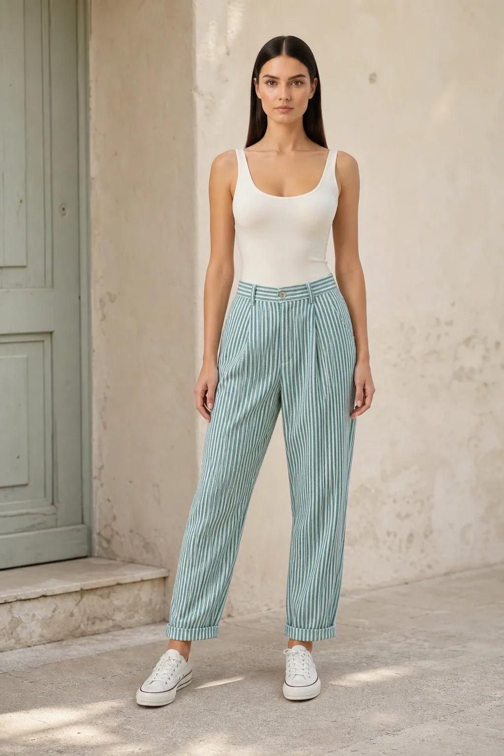 Green striped tapered joggers on a model in a contrapposto stance