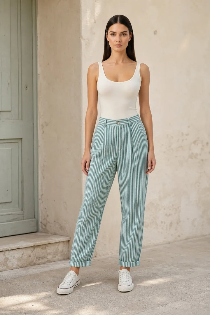 Green striped tapered joggers on a model in a contrapposto stance