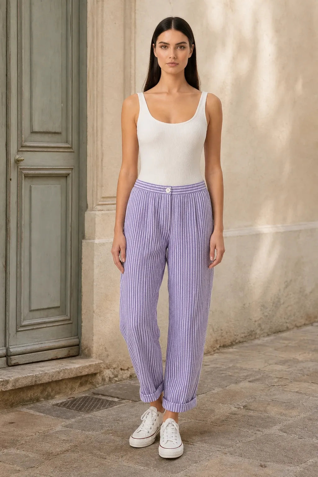 Purple striped tapered joggers on a model in a contrapposto stance