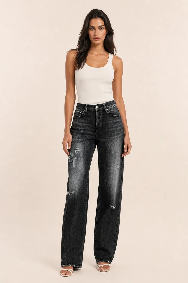 Black distressed wide-leg jeans on a model in a contrapposto stance