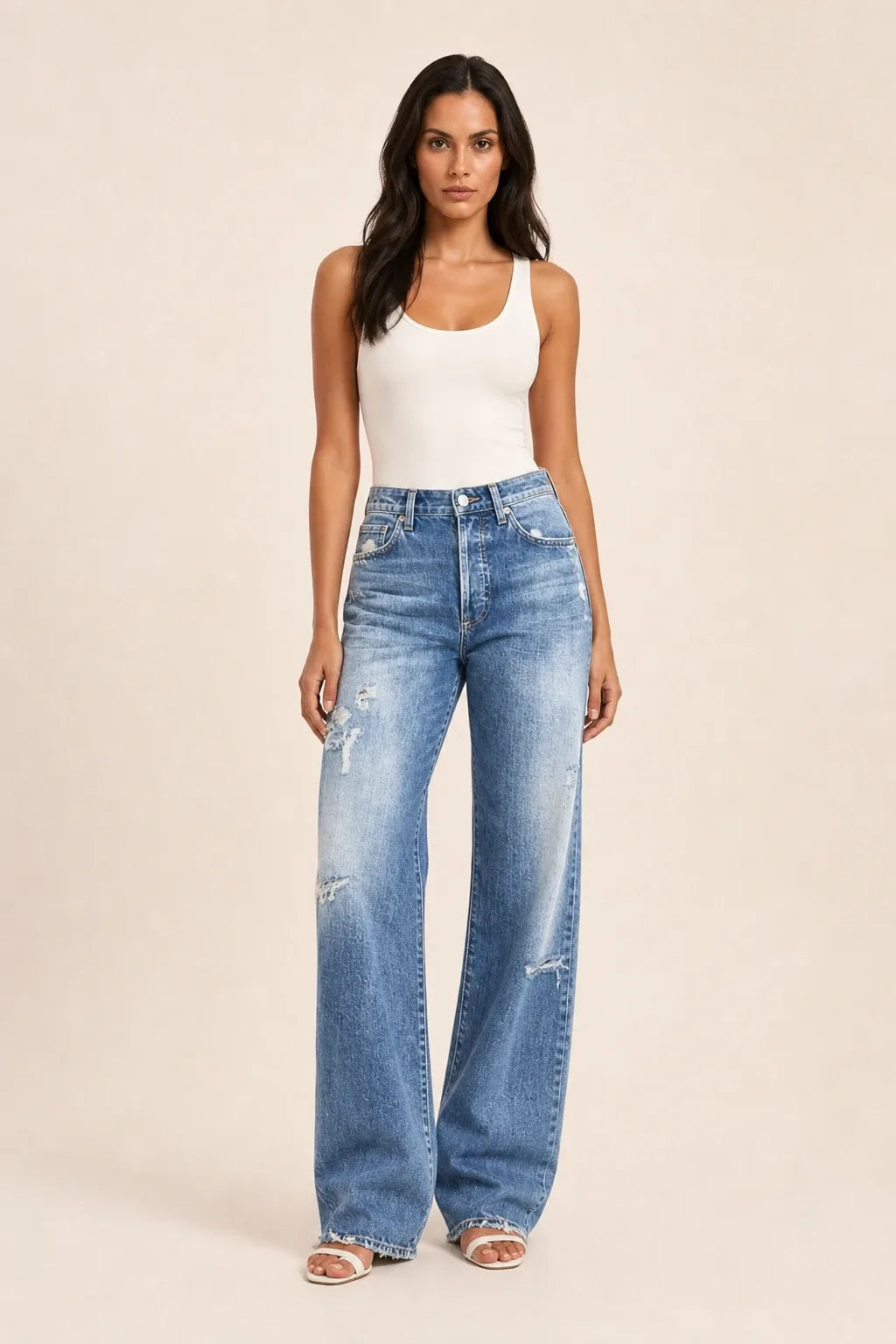 Blue distressed wide-leg jeans on a model in a contrapposto stance