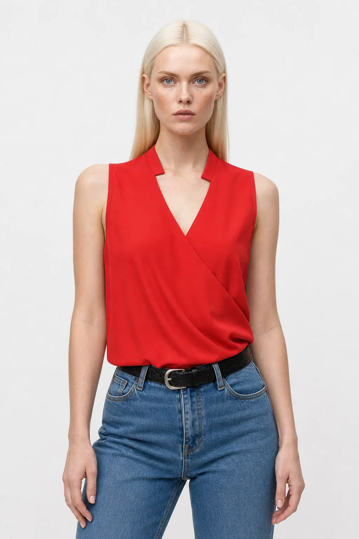 Red collared wrap blouse on model in contrapposto stance