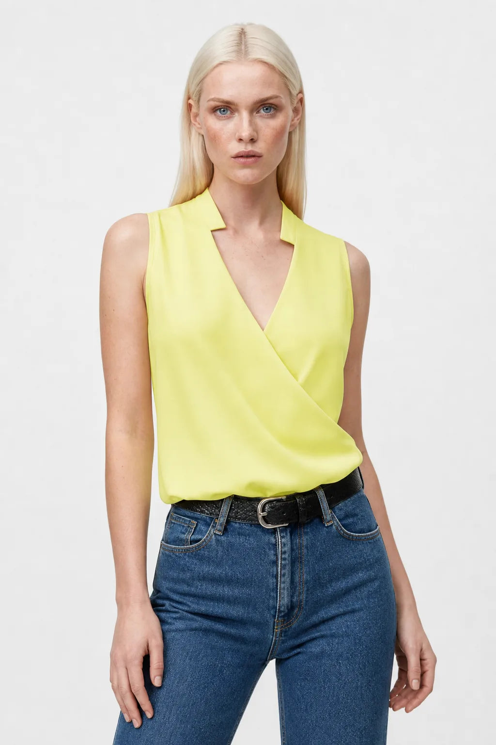 Yellow collared wrap blouse on model in contrapposto stance