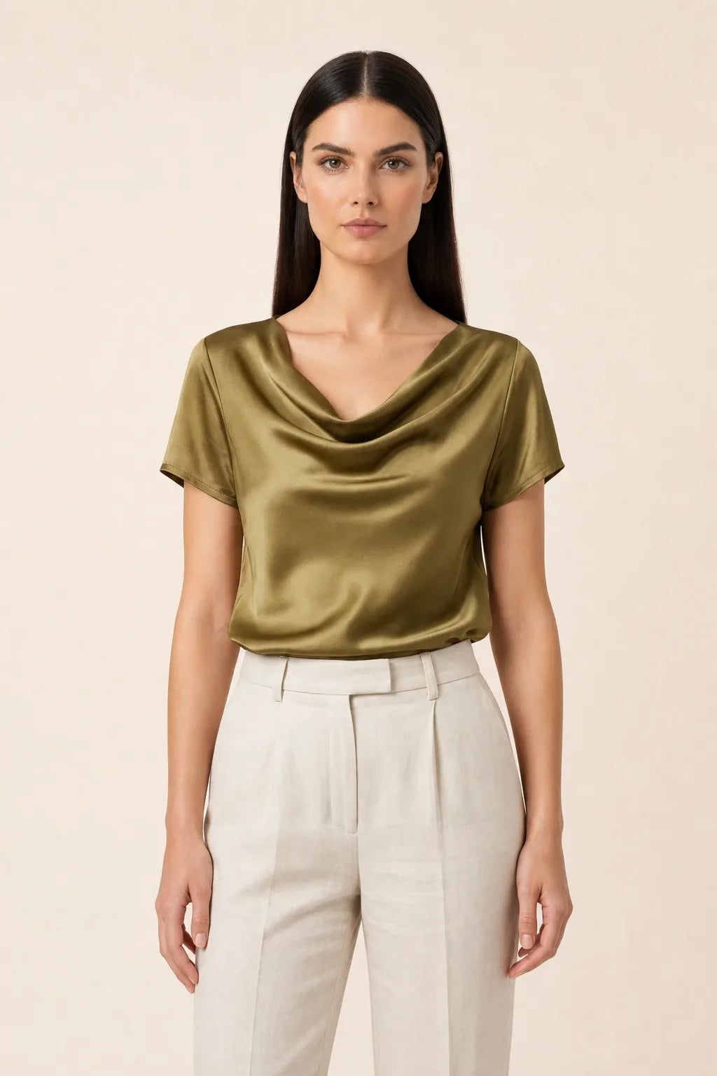 Gold satin cowl neck top on model in contrapposto stance
