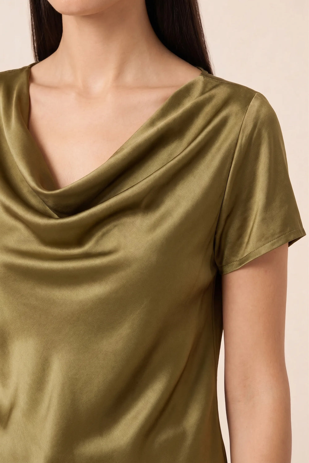 Close-up detail of gold satin cowl neck draping