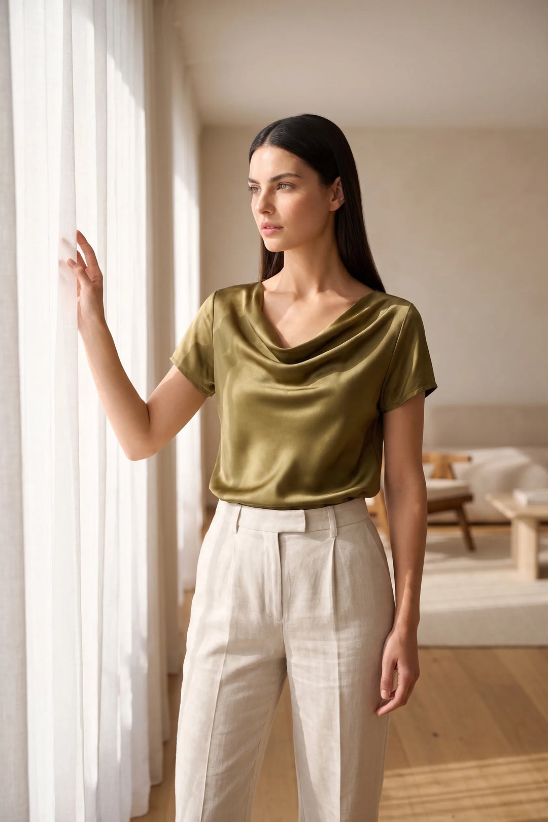 Model wearing gold satin cowl neck top in lifestyle setting