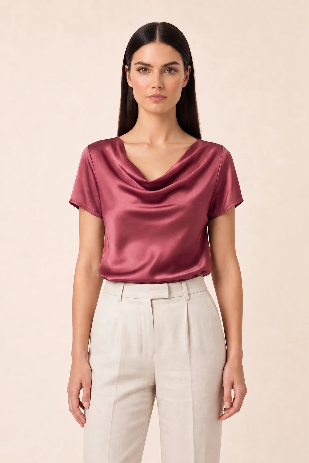 Pink satin cowl neck top on model in contrapposto stance