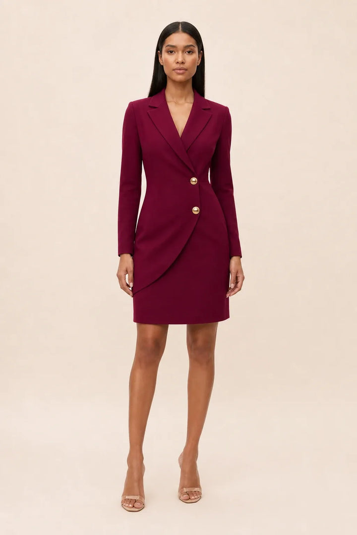 Burgundy notch lapel blazer dress on model in contrapposto stance
