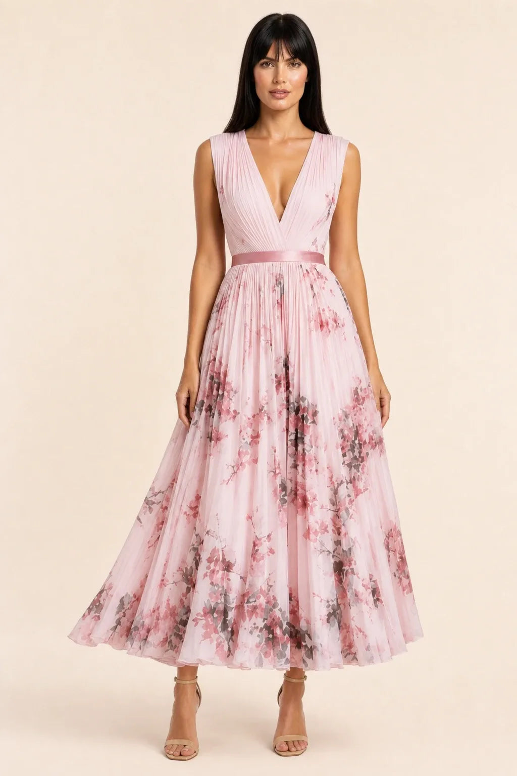 Pink pleated floral midi dress on model in contrapposto stance