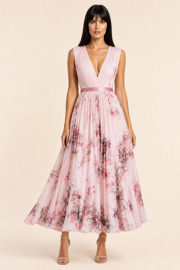 Pink pleated floral midi dress on model in contrapposto stance