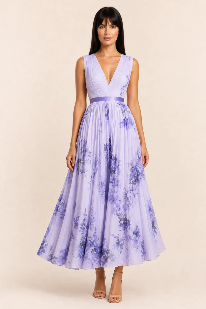 Purple pleated floral midi dress on model in contrapposto stance