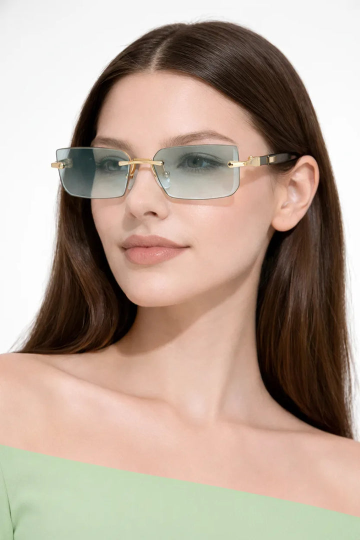 Rimless rectangle gradient sunglasses in light green worn on a model&