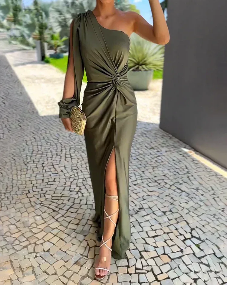 Woman wearing a green one-shoulder twist gown, facing forward