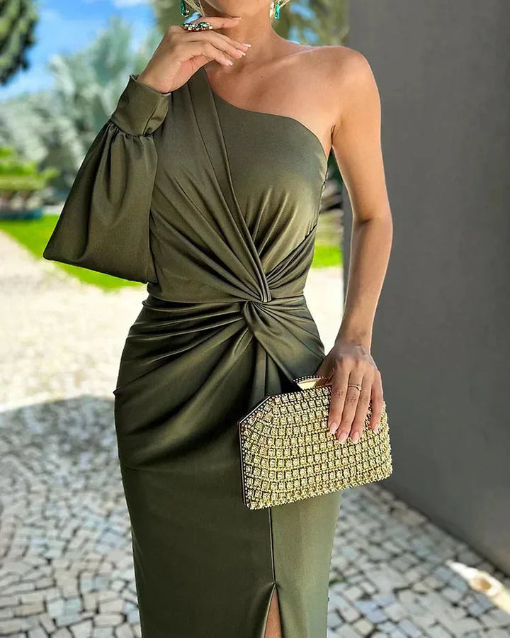 Woman in a green one-shoulder twist gown, turned at a three-quarter angle