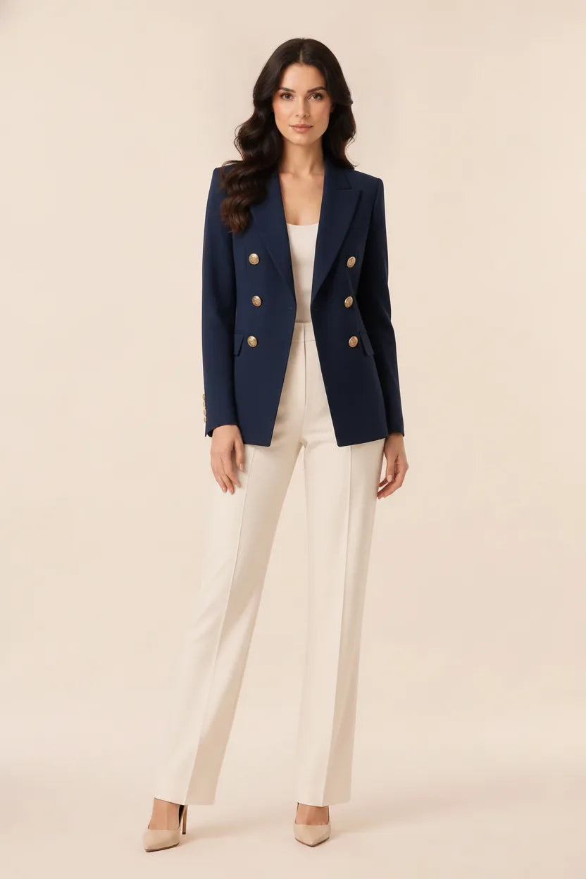 Black double-breasted blazer on model posed outside a storefront