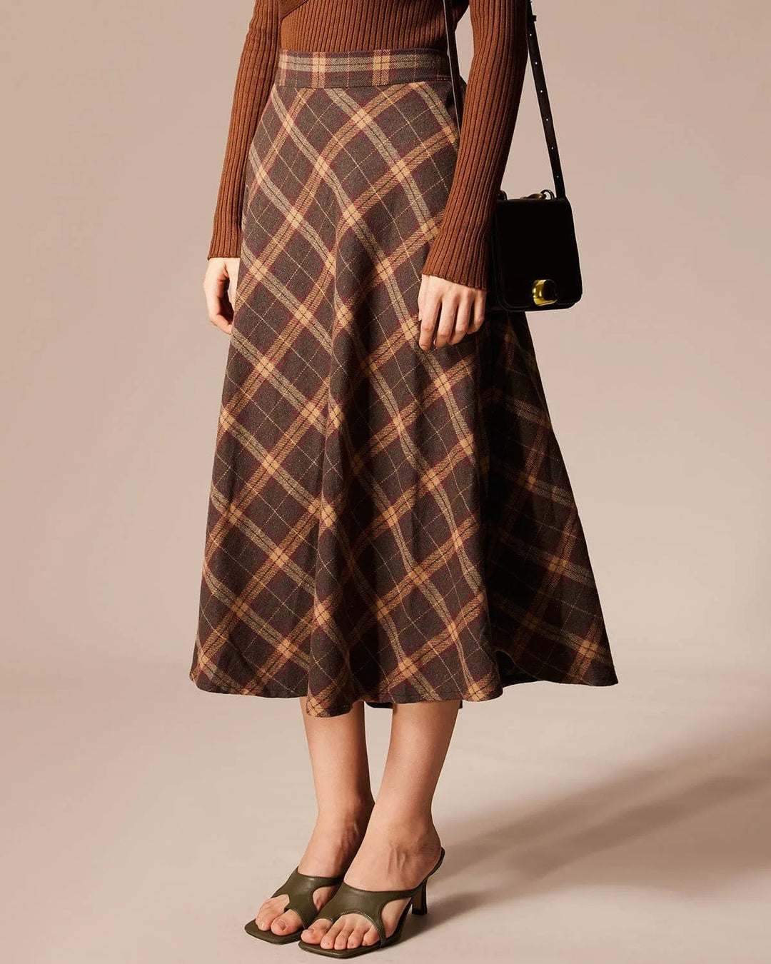 Brown plaid A-line midi skirt, model in side profile