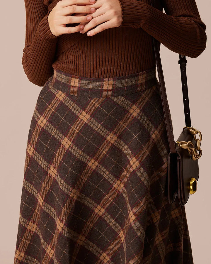 Brown plaid A-line midi skirt, model in three-quarter turn