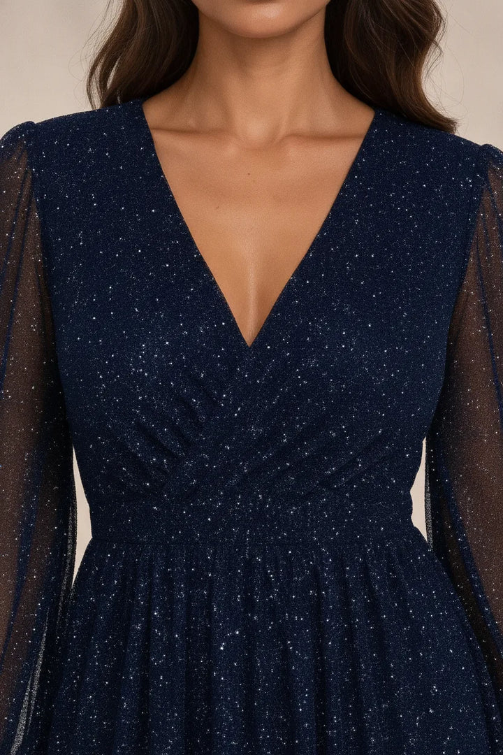 Close-up detail of navy blue glitter mesh mini dress fabric and construction