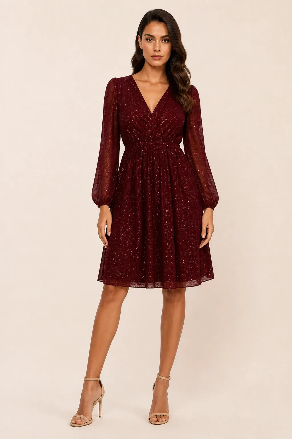 Red glitter mesh mini dress on a model in a contrapposto stance