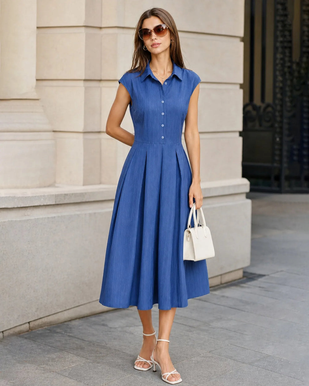 Close-up detail of the blue pleated fabric and dress construction