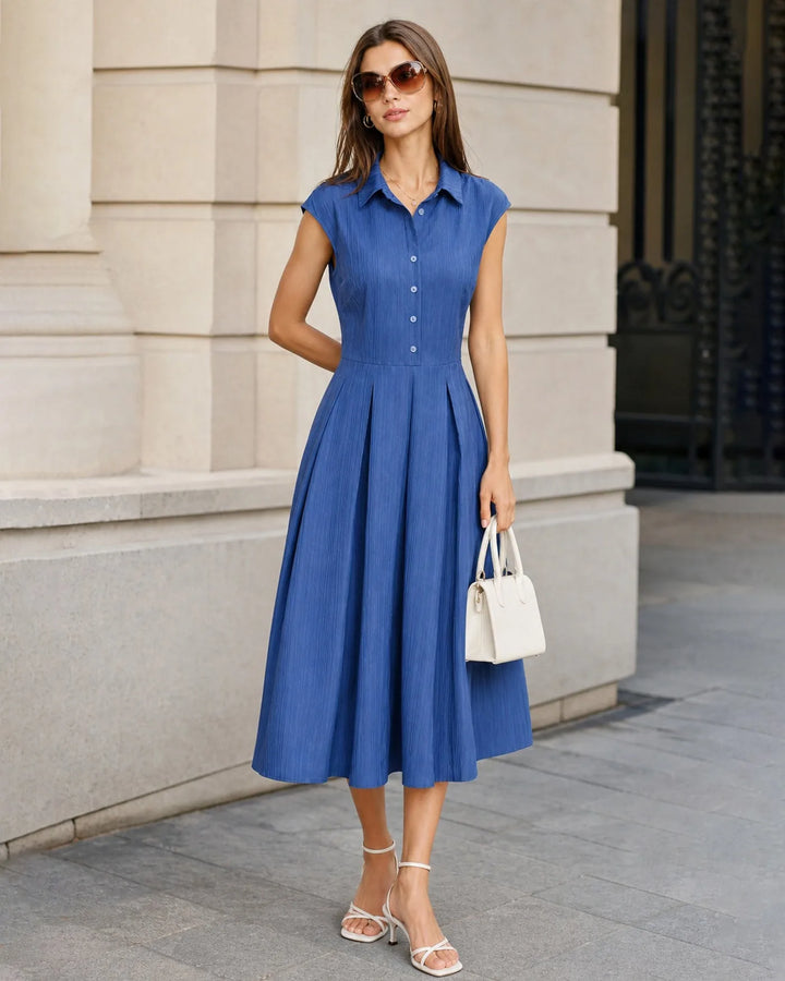 Close-up detail of the blue pleated fabric and dress construction