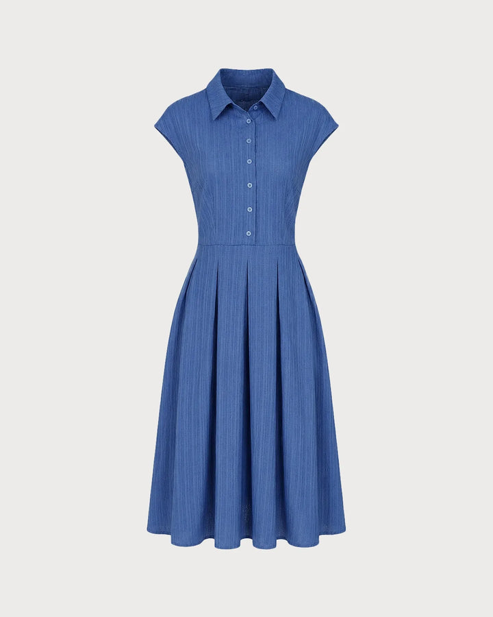 Model wearing a blue pleated midi dress with focus on the full-length fit