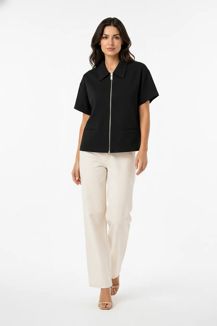 Black zip-front jacket on model in natural movement