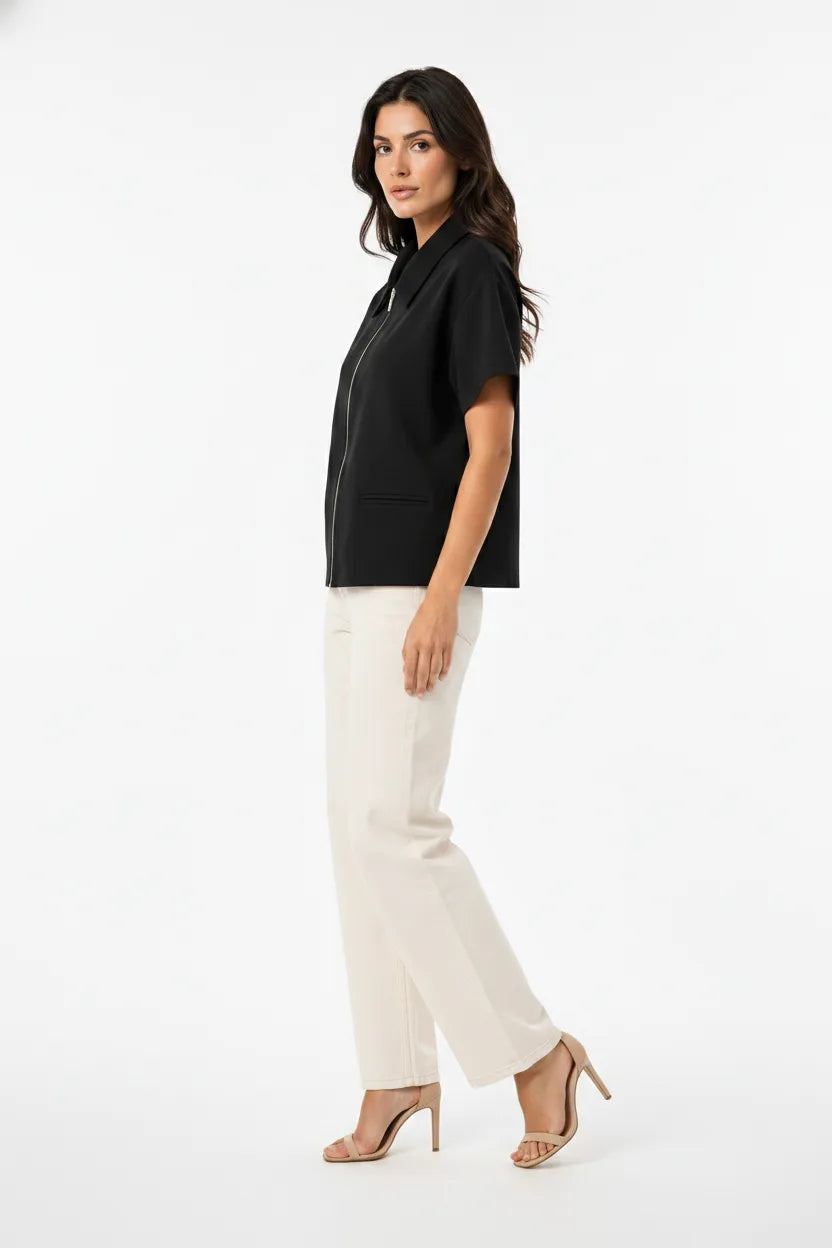 Black zip-front jacket on model in three-quarter turn