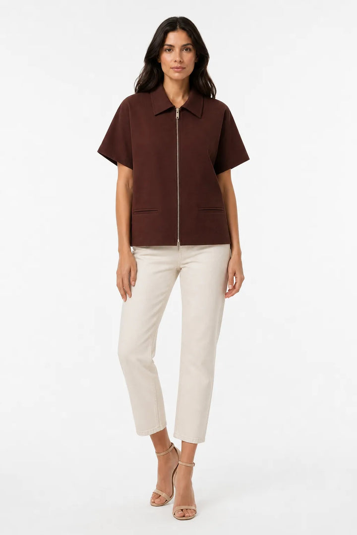 Brown zip-front jacket on model in contrapposto stance