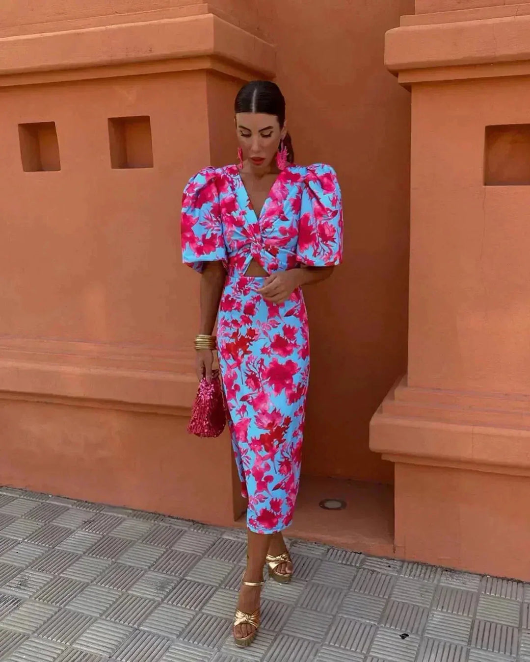 Blue midi dress with puff sleeves and cut-out detail, model facing forward