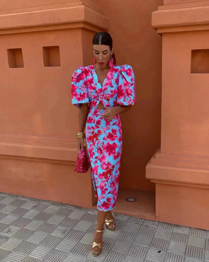 Blue midi dress with puff sleeves and cut-out detail, model facing forward