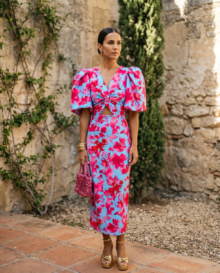Blue midi dress with puff sleeves and cut-out detail, model in side profile