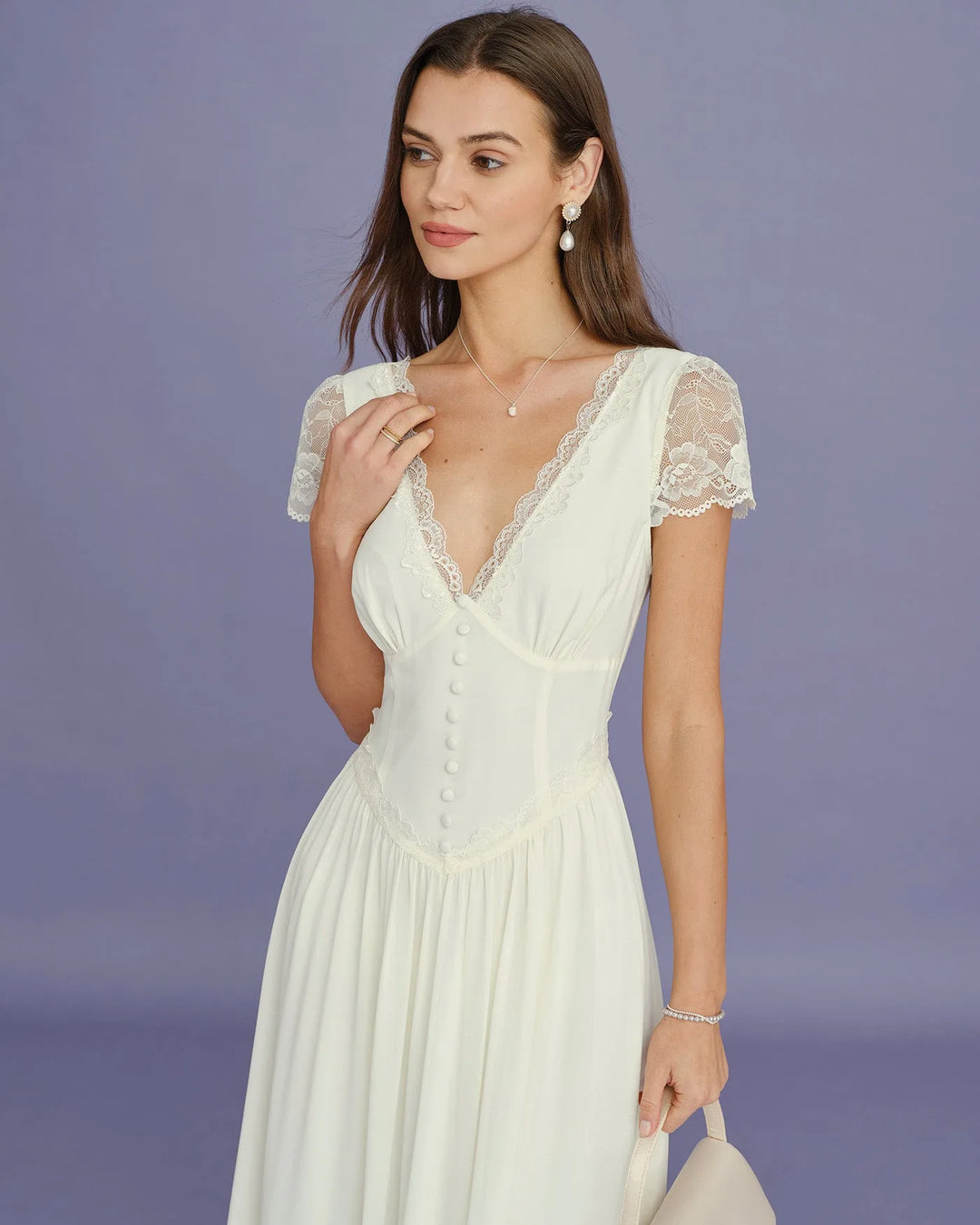 Model in three-quarter turn wearing apricot lace sleeve midi dress