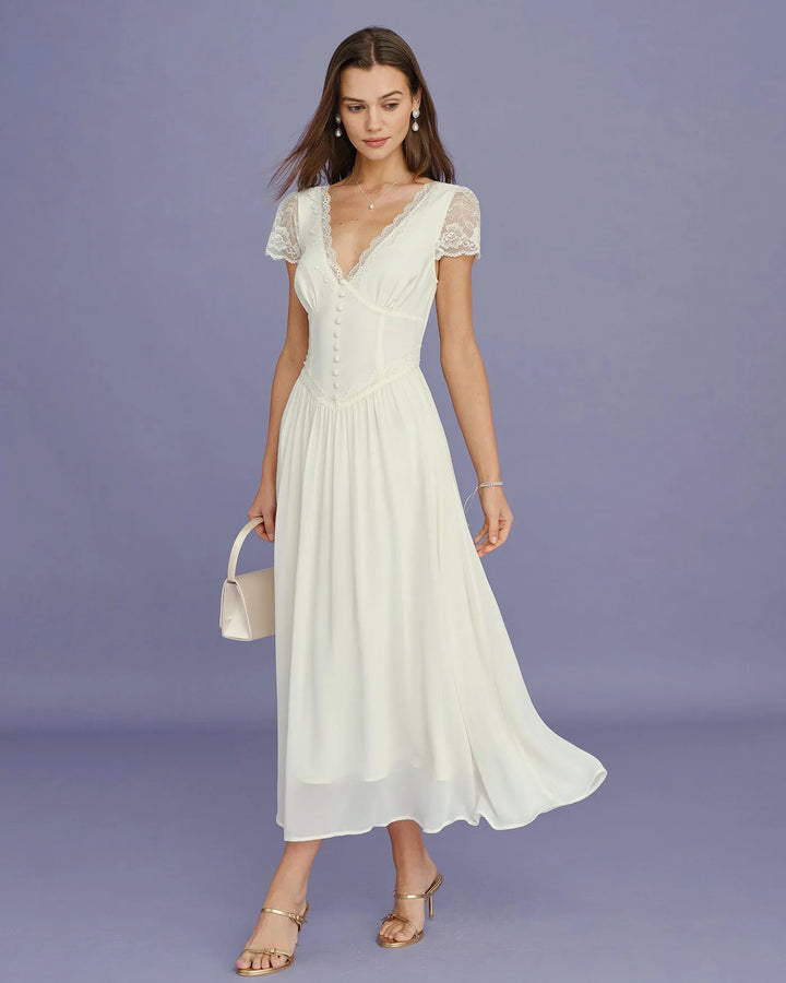 Model posing in apricot lace sleeve midi dress, alternate view
