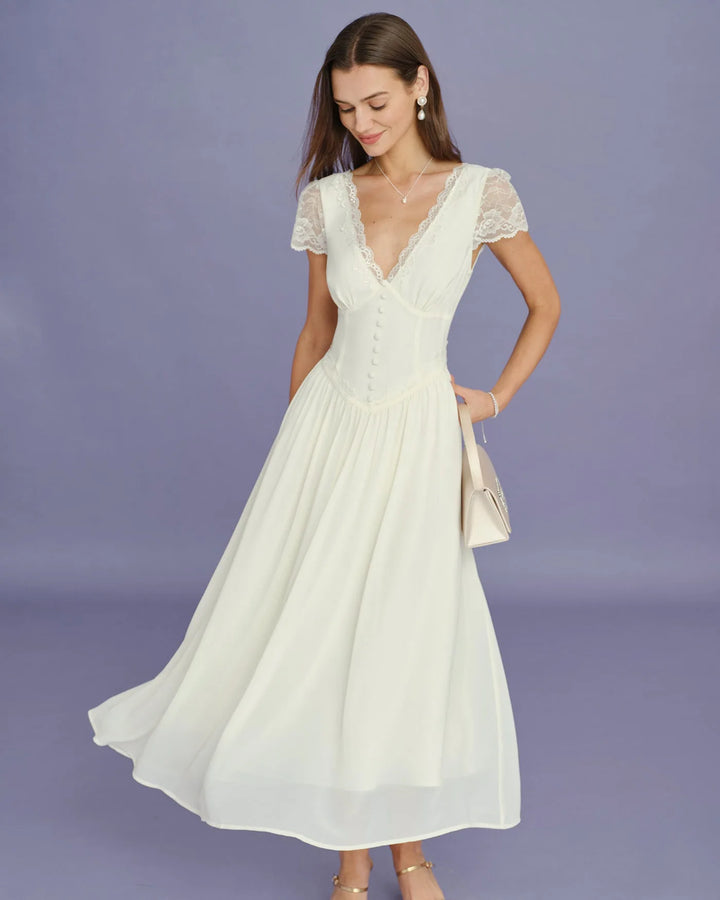 Model posing in apricot lace sleeve midi dress, full-length view