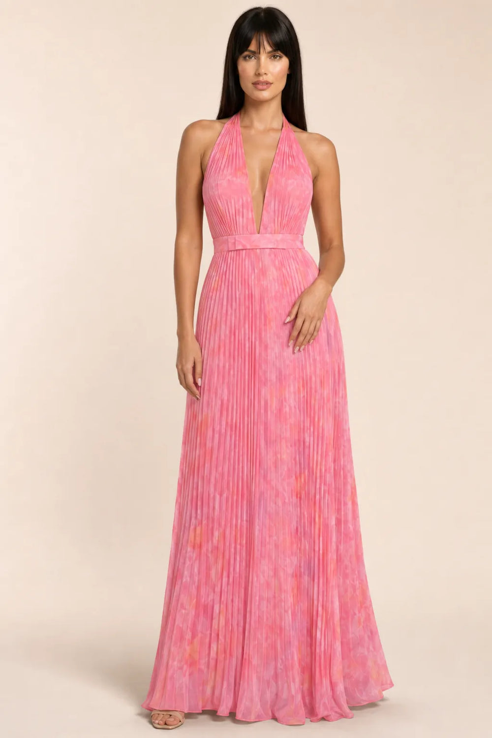 Pink pleated halter gown on model in contrapposto stance