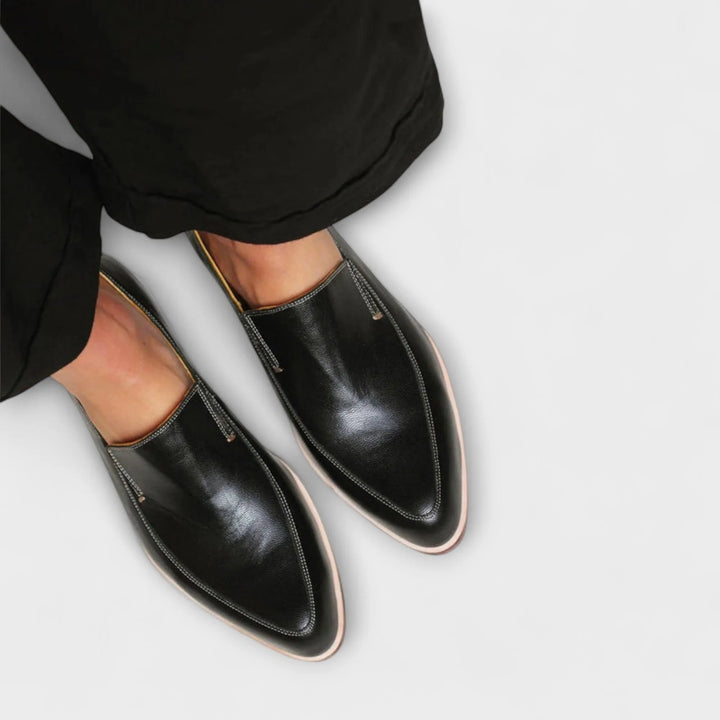 Black pointed toe loafer mule, side profile view