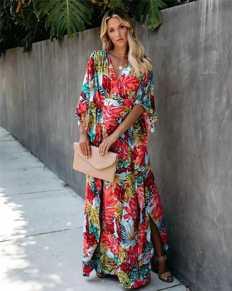 Close-up detail of red tropical-print wrap maxi dress fabric and tie