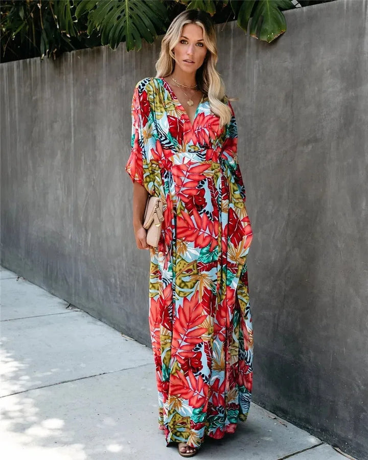 Red tropical-print wrap maxi dress on model at three-quarter turn
