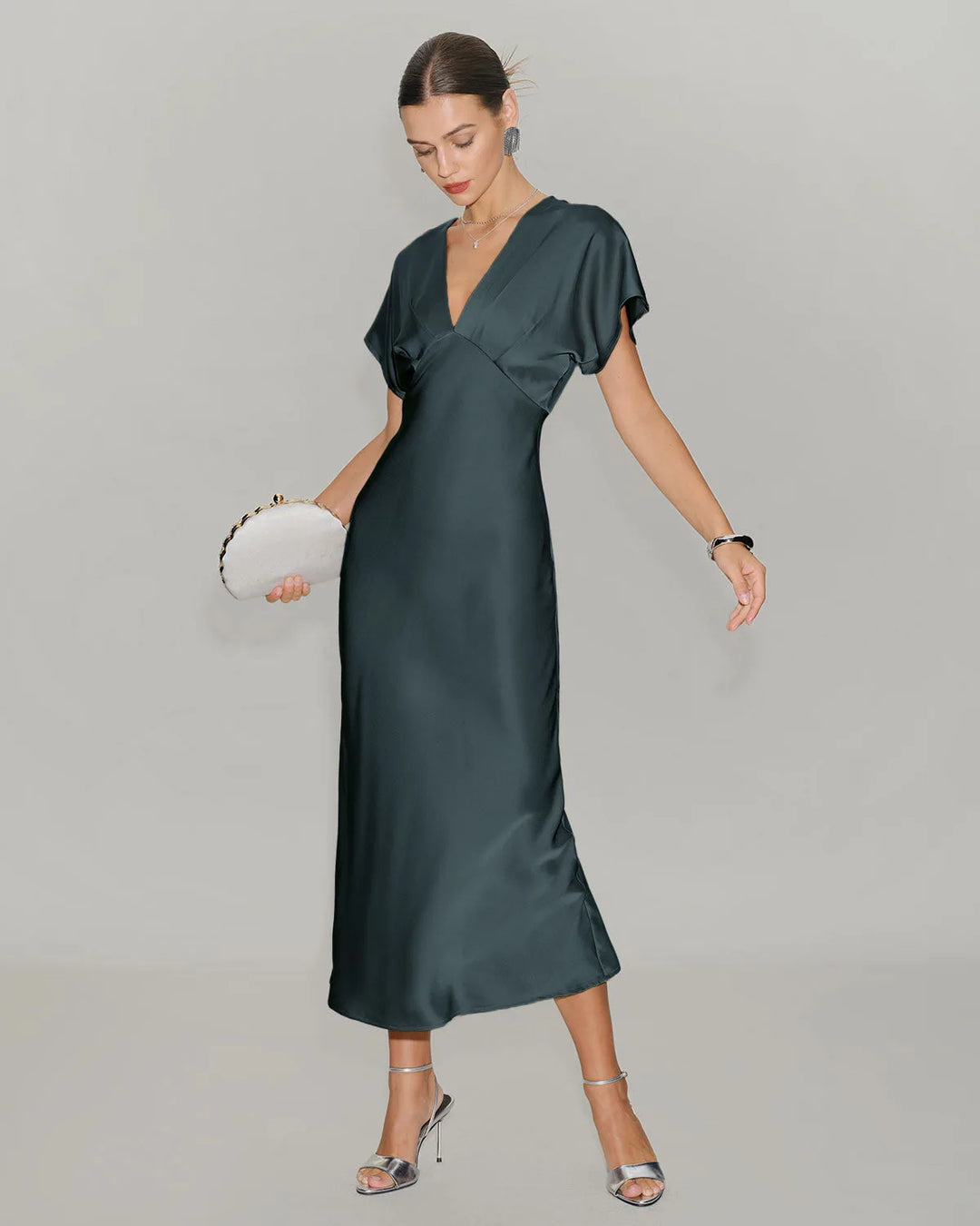 Close-up detail of grey flutter sleeve midi dress fabric and sleeve