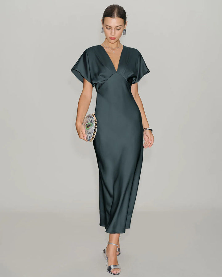 Grey flutter sleeve midi dress on standing model, side view
