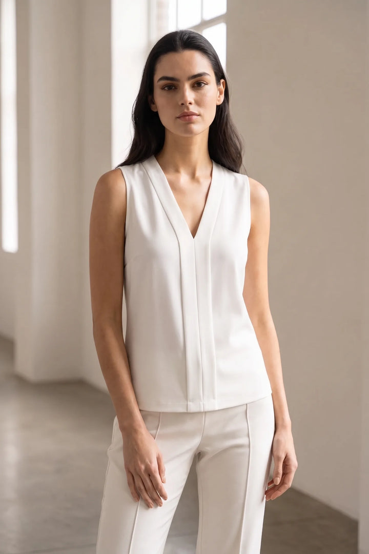 White centre pleat v-neck blouse styled in a casual lifestyle setting
