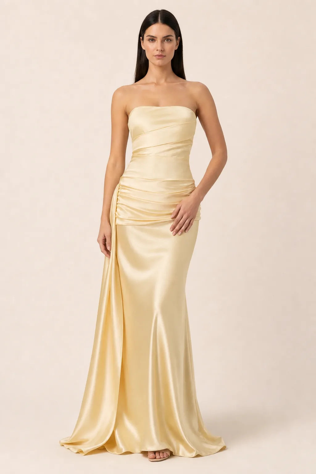 Apricot ruched satin gown with gathered bodice and floor-length skirt, model in contrapposto stance