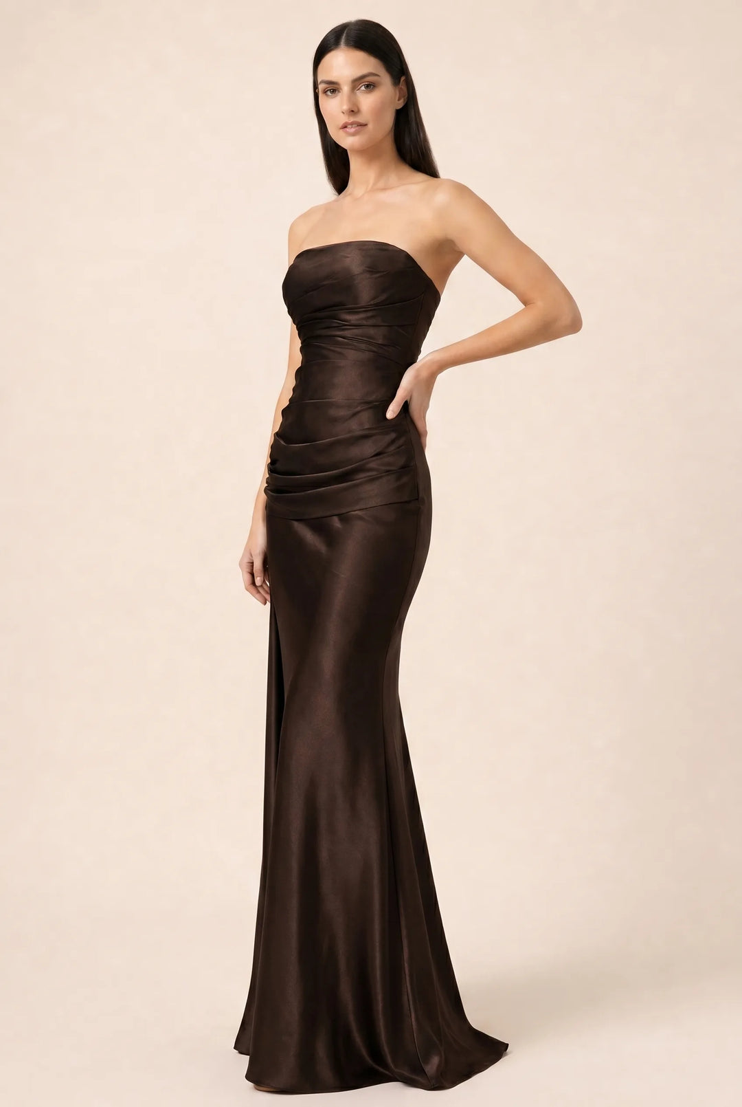 Brown ruched satin gown with gathered bodice and floor-length skirt, model in three-quarter turn