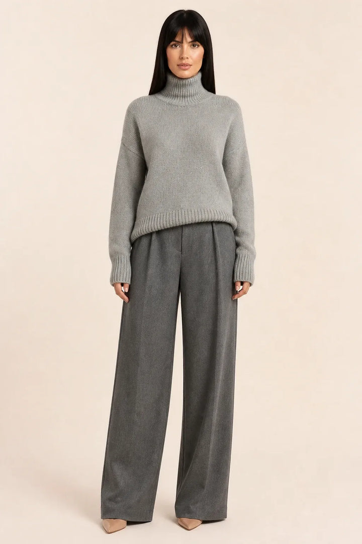 Gray turtleneck knit pullover on a model in a contrapposto stance