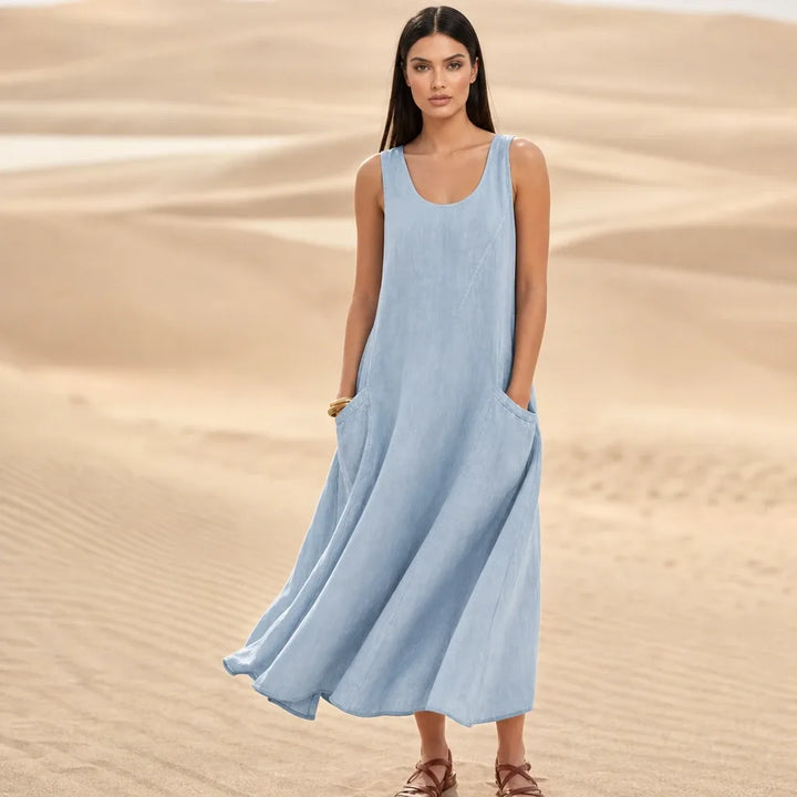 Light blue maxi dress with side pockets, model standing in contrapposto pose