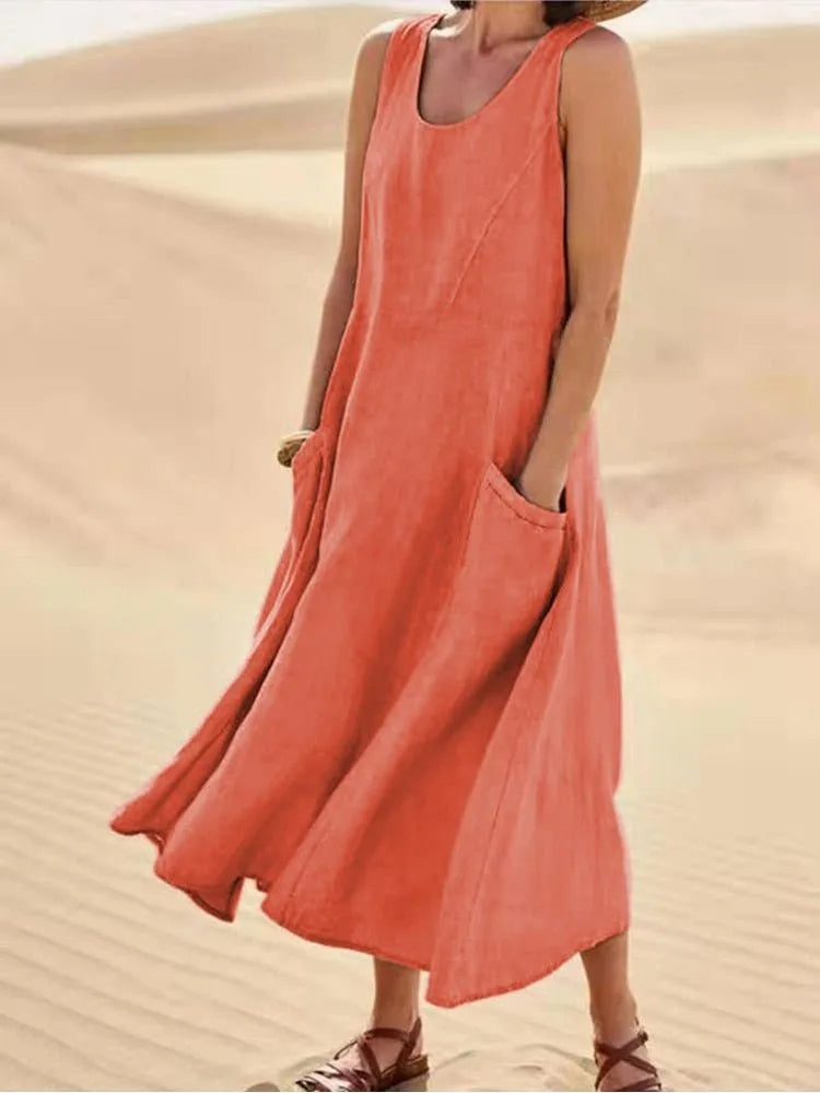 Orange maxi dress with side pockets, model in side profile