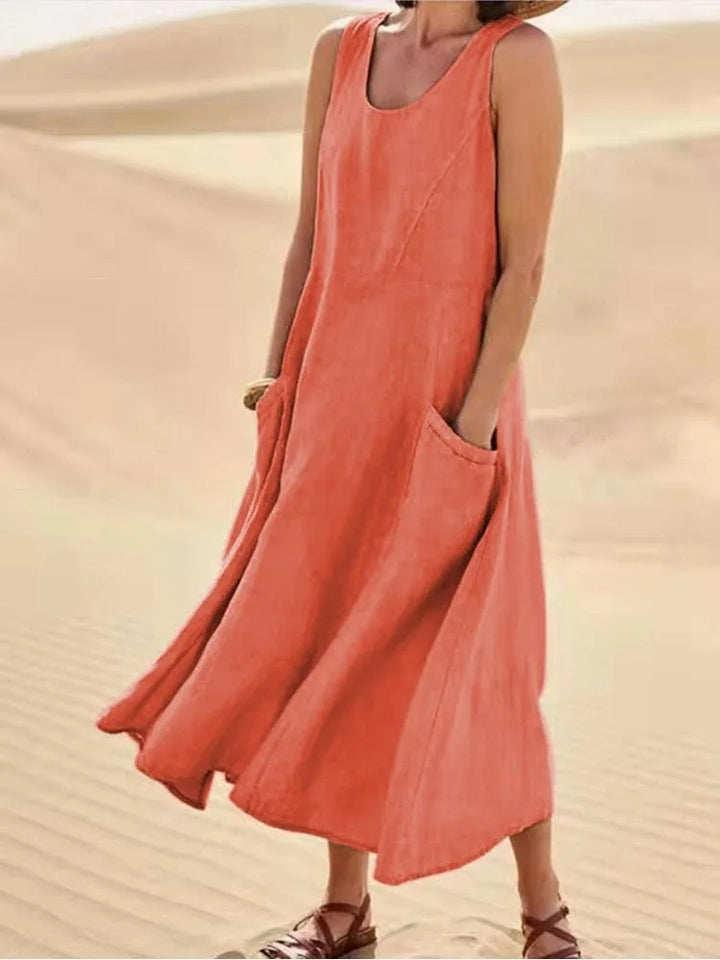 Orange maxi dress with side pockets, model in side profile