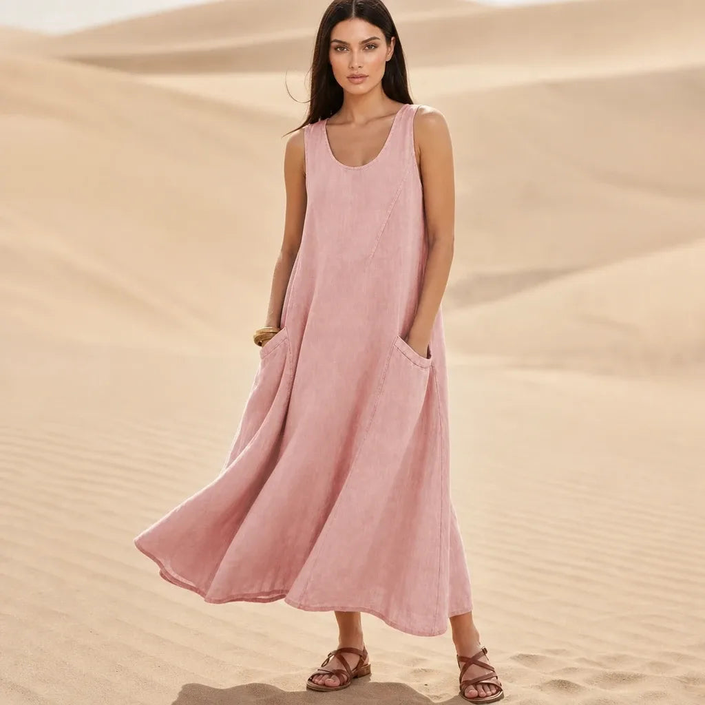 Pink maxi dress with side pockets, model standing in contrapposto pose