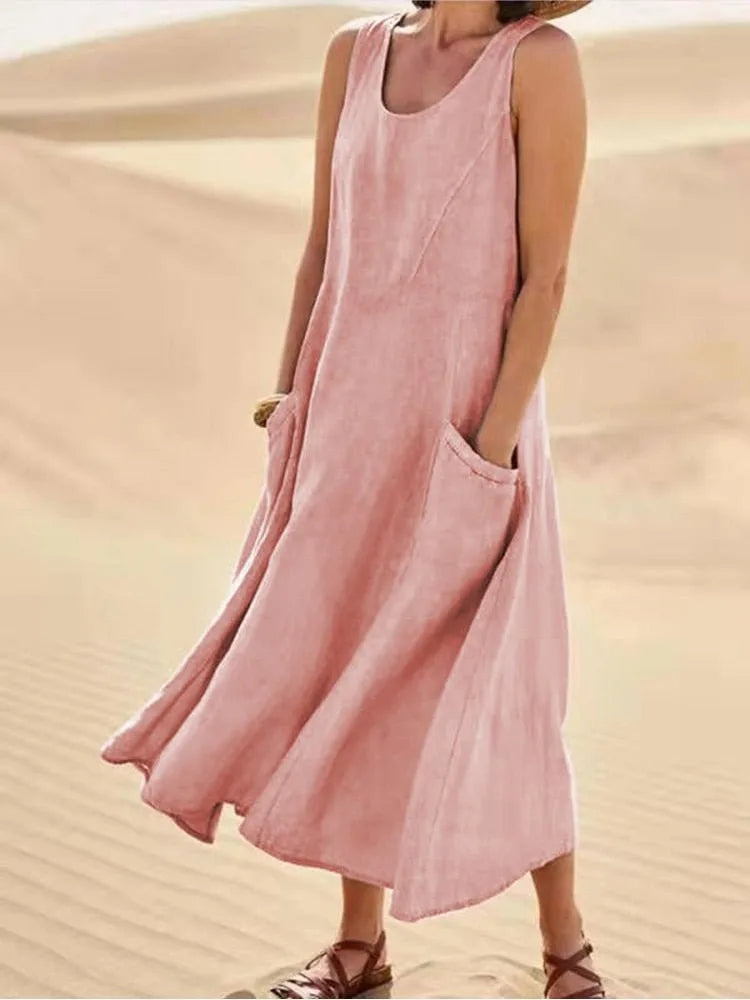 Pink maxi dress with side pockets, model in three-quarter turn
